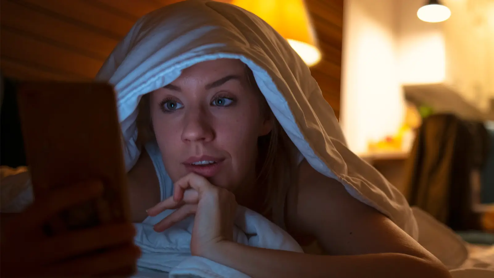 Woman on phone in bed