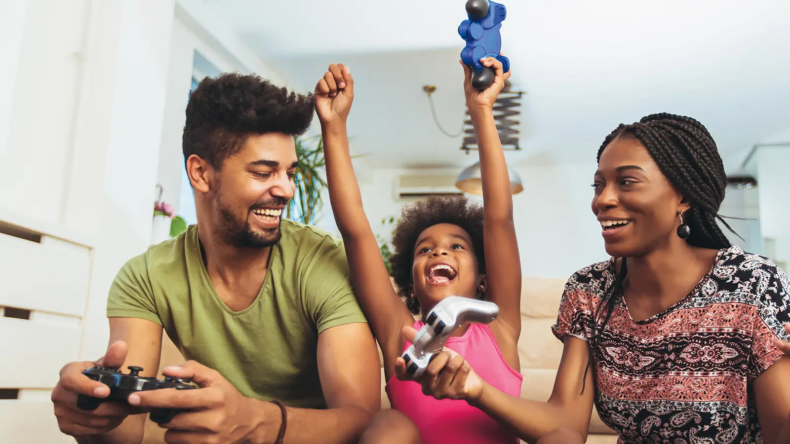 Family playing video games at home.